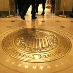 Fed holds rates steady and notes progress on inflation