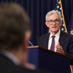 Fed holds rates steady, takes less confident view on inflation